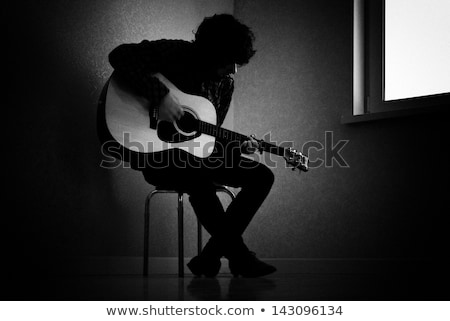 Foto stock: Playing Acoustic Guitar By The Window