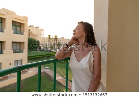 Stock foto: Young Beautiful Woman In Bikini Leaning On A Railing At The Beach