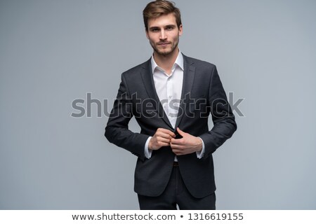 Foto stock: Happy Handsome Businessman Buttoning Jacket