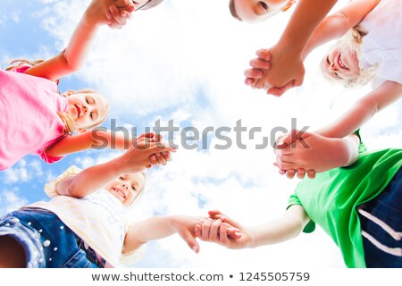 Stock photo: Many Arms Of Children Holding Hands Together