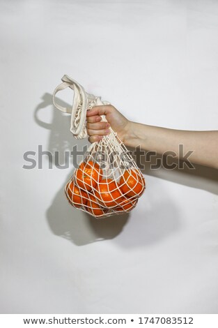 Stockfoto: Basket Of Mandarins In The Hands Of A Man
