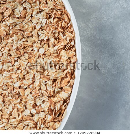 Stock fotó: Close Up White Bowl With Dry Oat Flakes For Preparing Healthy Porridge On A Gray Stone Background