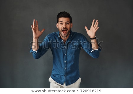 Stock foto: Smiling Casual Man Standing And Making Open Gesture With Hands