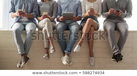 Foto stock: Cropped Image Of Young Casual Man Using Mobile Phone