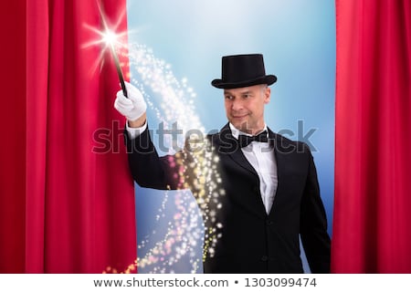 Stock photo: Mature Magician Doing Magic With Illuminated Wand