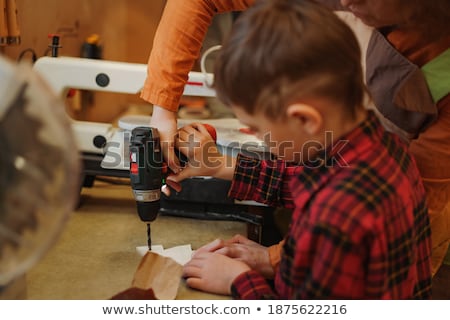 Stockfoto: Craftsman Holding A Little Electric Saw