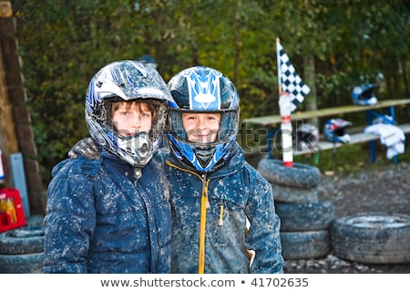 Imagine de stoc: Child Loves To Race With A Quad Bike At The Muddy Quad Track