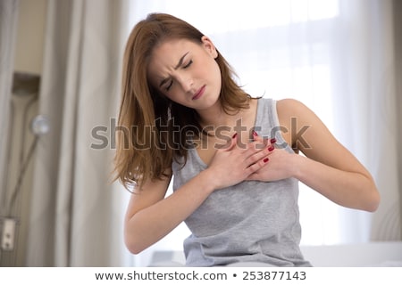 Сток-фото: Young Woman In Pajamas Having Heart Attack