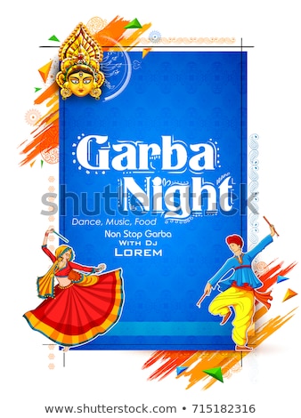 Imagine de stoc: Couple Playing Dandiya In Disco Garba Night Poster For Navratri Dussehra Festival Of India