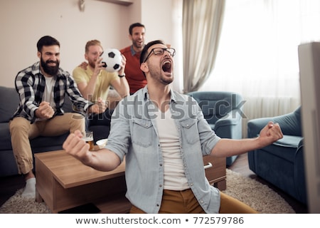 Stockfoto: Friends Or Football Fans Watching Soccer At Home