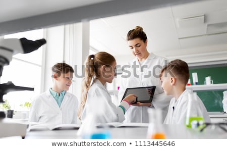 Stockfoto: Teacher With Tablet Pc And Kids At Chemistry Class