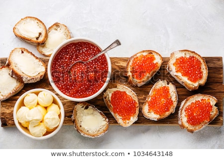 Stockfoto: Salmon Red Caviar In Bowl And Sandwiches With On Wooden Cutting Board