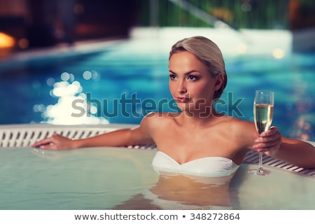 Foto stock: Happy Young Woman In Swimsuit Drinking Champagne