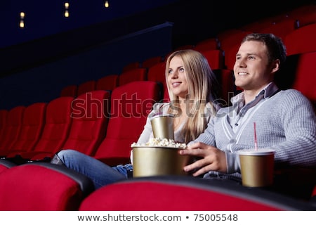 Foto d'archivio: Young Couple Sitting At Red Movie Theatre