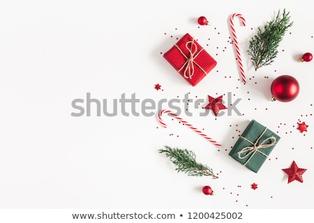 Stock fotó: Candy Cane And Christmas Ball On Fir Tree Branch