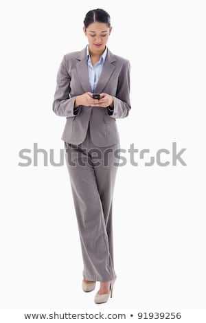 Stock fotó: Portrait Of A Smiling Brunette Businesswoman Sending A Text Message Against A White Background