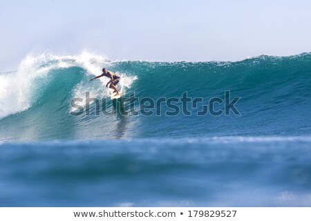 Stok fotoğraf: Boy Surfer Surfing Waves On The Beach