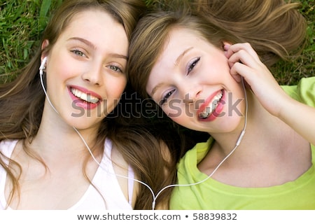 Сток-фото: Teenage Girl Lying On Grass With Mp3 Player