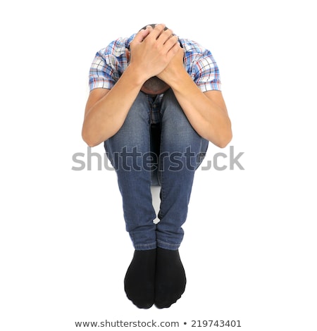 Foto stock: Young Man Curled Up In The Floor With His Head Between His Knees