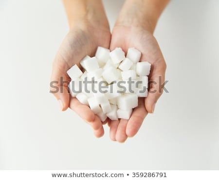 ストックフォト: Close Up Of White Lump Sugar In Woman Hands