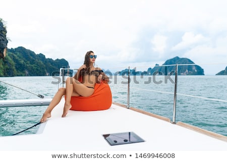 Foto stock: Gorgeous Woman Wearing Hat Sitting On The Yacht