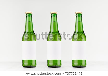 ストックフォト: Three Green Longneck Beer Bottles 330ml With Blank White Label On White Wooden Board Mock Up