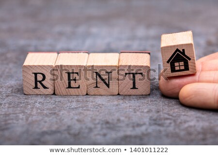 Stok fotoğraf: Hand Placing House Icon Wooden Block Beside Rent Word Blocks