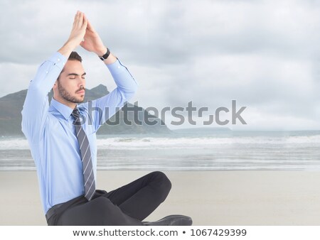 Zdjęcia stock: Business Man Meditating Against Blurry Beach