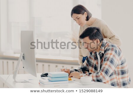 Zdjęcia stock: Husband And Wife Work On Paper Report Together Check Information Sit In Front Of Computer Drinks