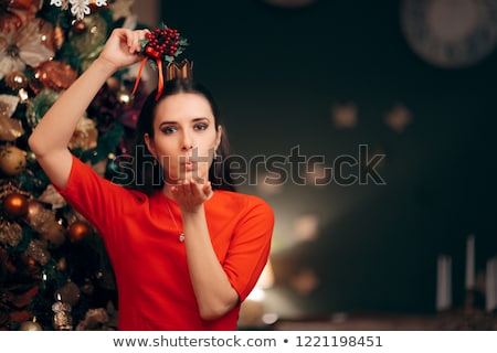 Stock photo: Woman Holding Mistletoe Kissing