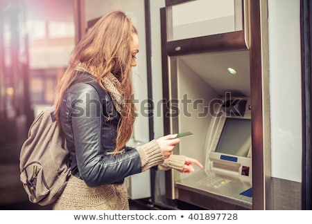 Foto d'archivio: Woman Withdrawing Money From Credit Card At Atm