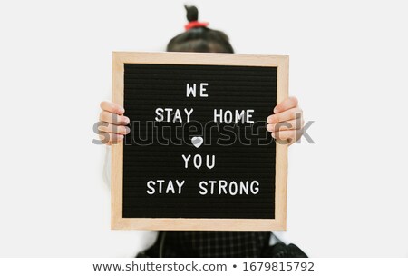 Stock photo: Lovely Girl Holding Crisis Word Board