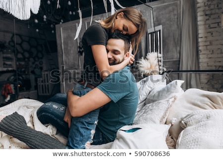 ストックフォト: Lovely Couple Hugging On A Bed