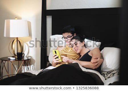 Foto stock: Happy Gay Couple Looking At Pictures On Mobile Phone