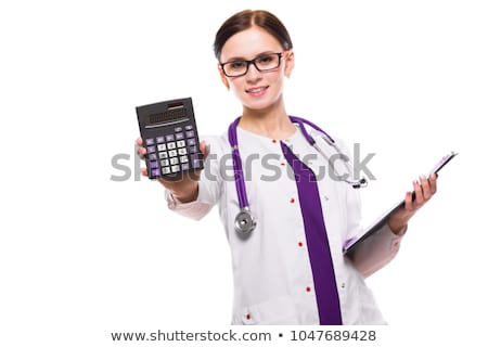 ストックフォト: Young Beautiful Female Doctor Holding Clipboard And Calculator In Her Hands On White Background