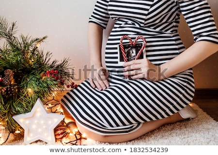 Foto stock: Close Up Of Pregnant Woman With Heart At Christmas