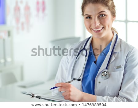 Foto stock: Smiling Medical Doctor Woman With Stethoscope And Clipboard