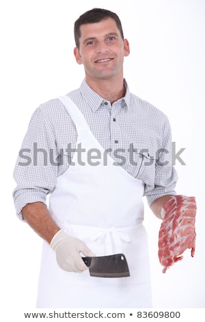 Stok fotoğraf: A Butcher Taking A Chopper And Pork Ribs