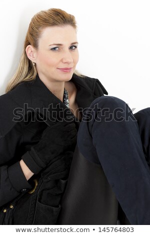 Foto stock: Portait Of Sitting Woman Wearing Black Clothes And Boots With A