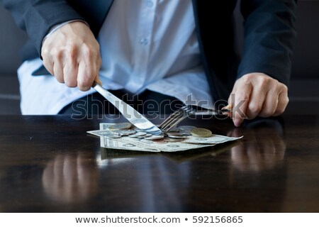 Foto stock: Woman Eating Hundred Dollar Bill For Dinner