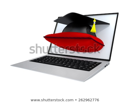 Foto stock: Graduate Cap On Cushion Out Of A Laptop