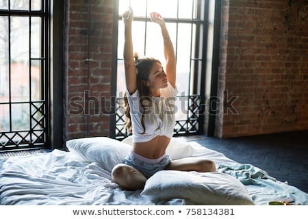 Stok fotoğraf: Young Sleepy Woman Stretching With Closed Eyes