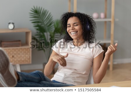 Stock photo: Inspired Woman Listening To Music And Imitating Playing The Guitar