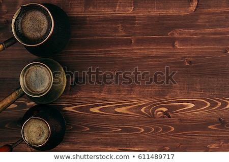 Stock photo: Hot Coffee In Shabby Turkish Pots Cezve With Tasty Crema On Brown Old Wooden Board Background Top