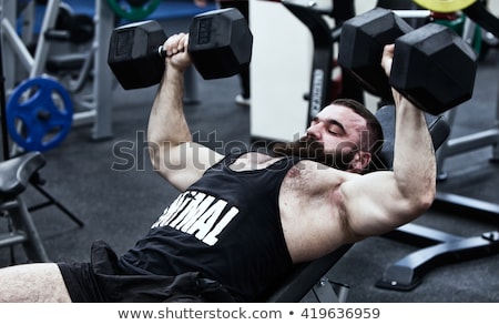 Stok fotoğraf: Shirtless Man Lifting Heavy Dumbbell On Bench
