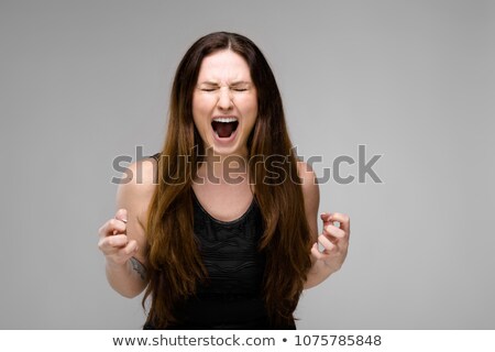 Foto stock: Emotional Plus Size Model Standing In Studio With Open Mouth Screaming Showing Agression Anger Want