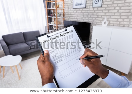 Stok fotoğraf: Man Filling Real Estate Appraisal Form