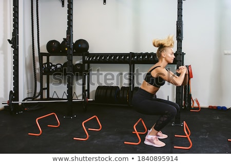 Stockfoto: Young Sports Woman Jumping Make Sport Exercises Isolated Indoors