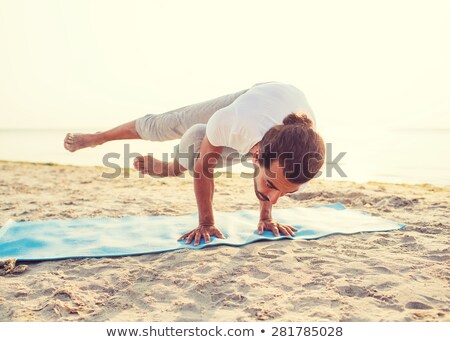 Stock fotó: Young Man Doing A Handstand In The Sea