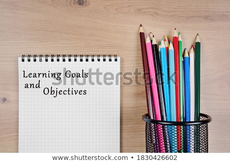 Stok fotoğraf: Objectives Word And Office Tools On Wooden Table